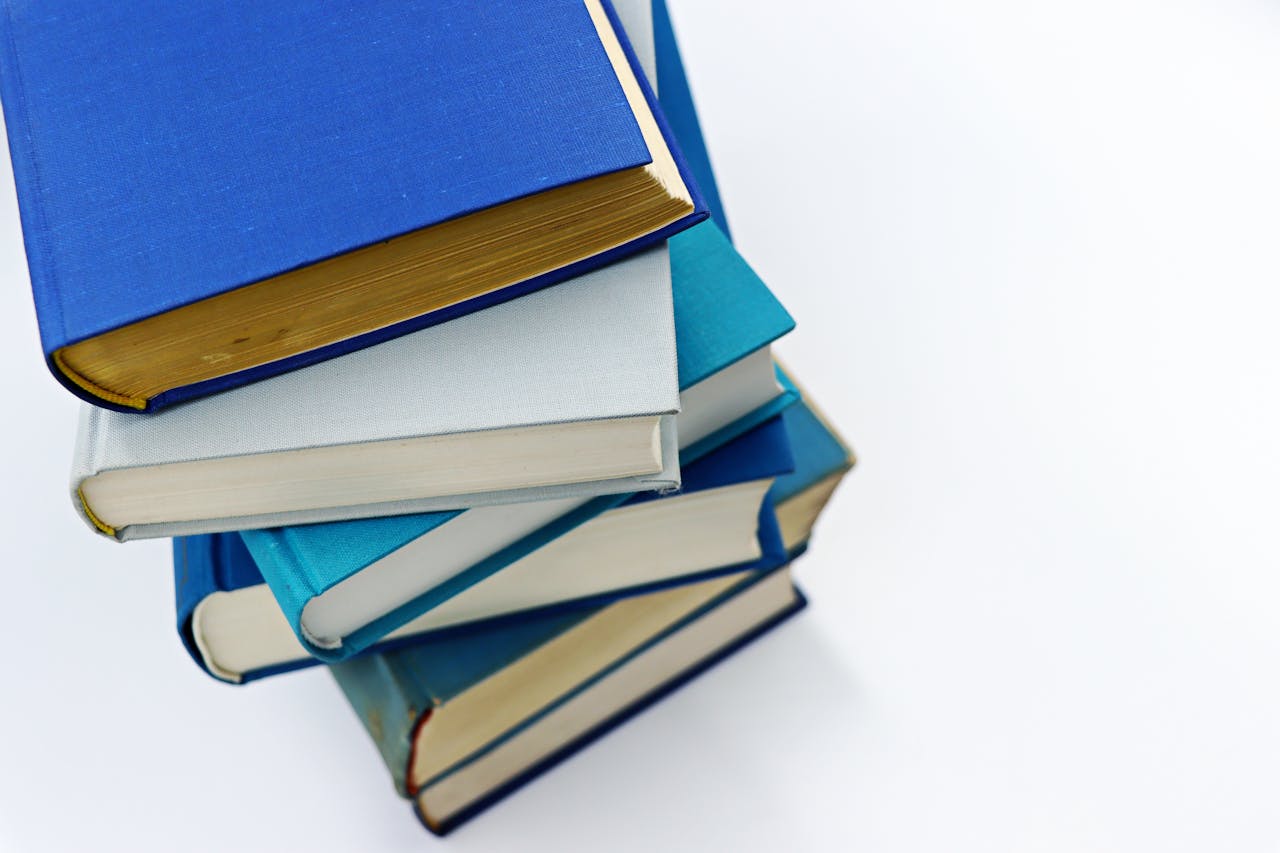 Crafting Captivating Headlines: Your awesome post title goes here A vertical stack of books with blue covers on a white background symbolizes education and literature.